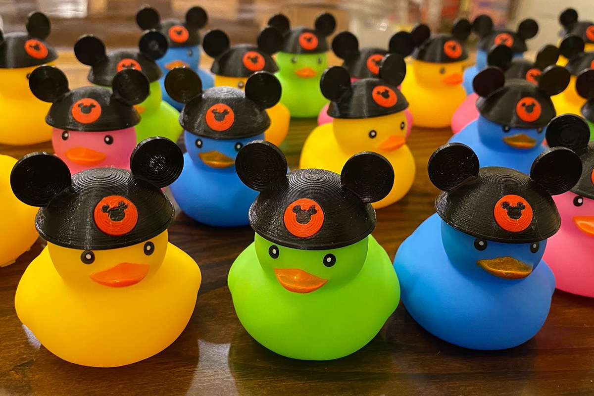 Several brightly colored rubber ducks wearing Mickey Mouse ear hats