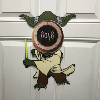 Full body Yoda with lightsaber decoration integrated into the stateroom number sign