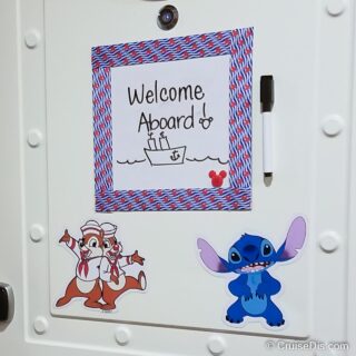 Close up of dry erase sheet decorated with a ribbon border and a Mickey Mouse plastic button