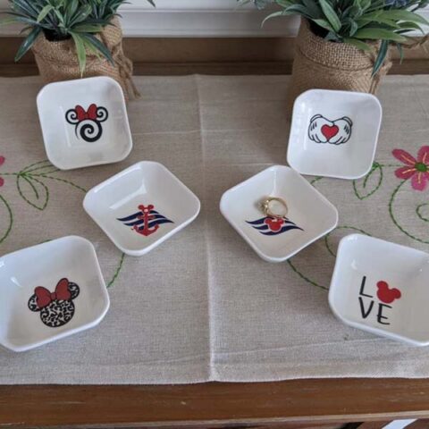 Six small jewlery dishes with different Mickey, Minnie, and Disney Cruise Line designs.