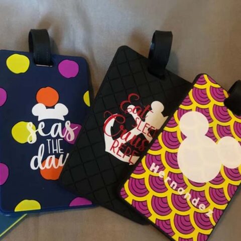 Three Disney themed luggage tags with the following designs: #1 "Seas the Day" saying with polka dots and a Mickey ears icon, #2 "Eat, sleep, cruise, repeat" saying with a Mickey topped ship anchor, and #3 a large Mickey Mouse icon with the family's name below.