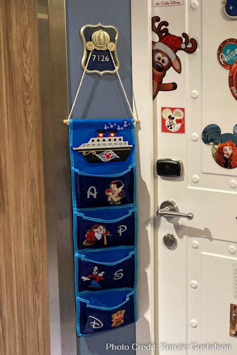 Black fish extender with blue trim has a Disney Cruise Line ship patch on the top panel, and pockets with Snow White, Grumpy, Goofy, and Fozzy Bear